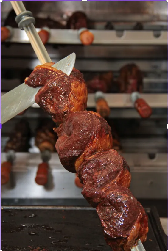 Picanha skewers turning over the churrasco grill