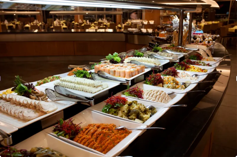 The market table: seasonal salads, charcuterie and Brazilian sides laid out for guests